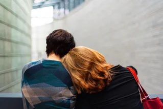 Friends leaning heads onto one another for support