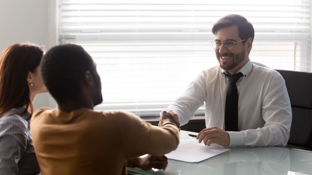Advisor shakes hands with couple.